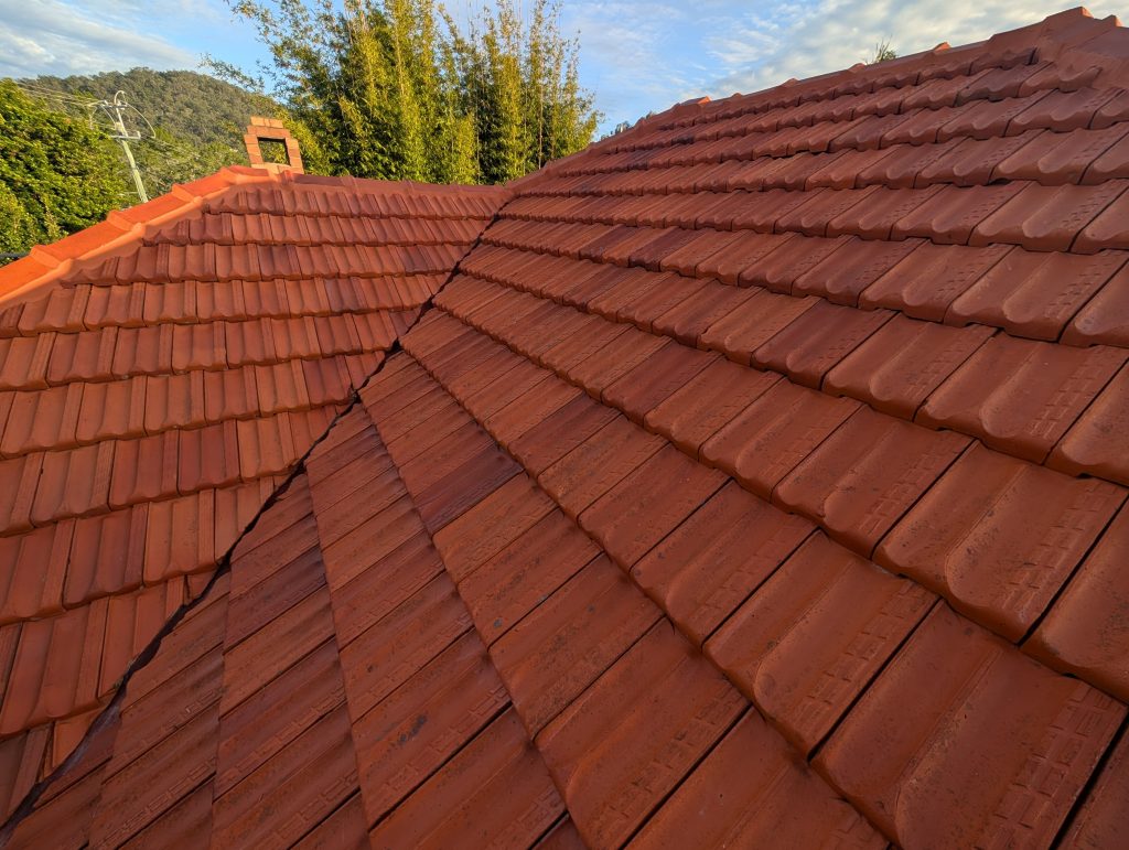 Terracotta tile roof restoration by Fix Up My Roof in Ashgrove, showing clean, shiny tiles